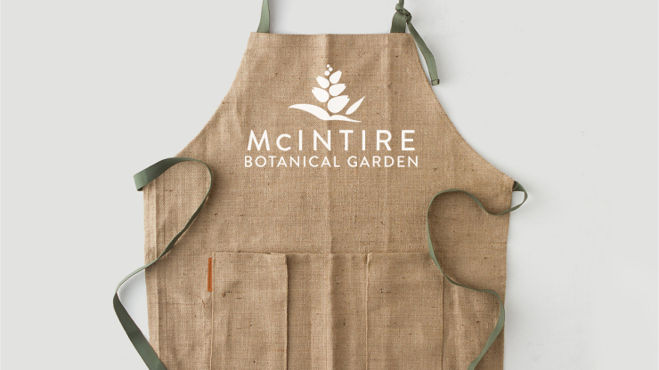 The new McIntire Botanical Garden logo on an apron