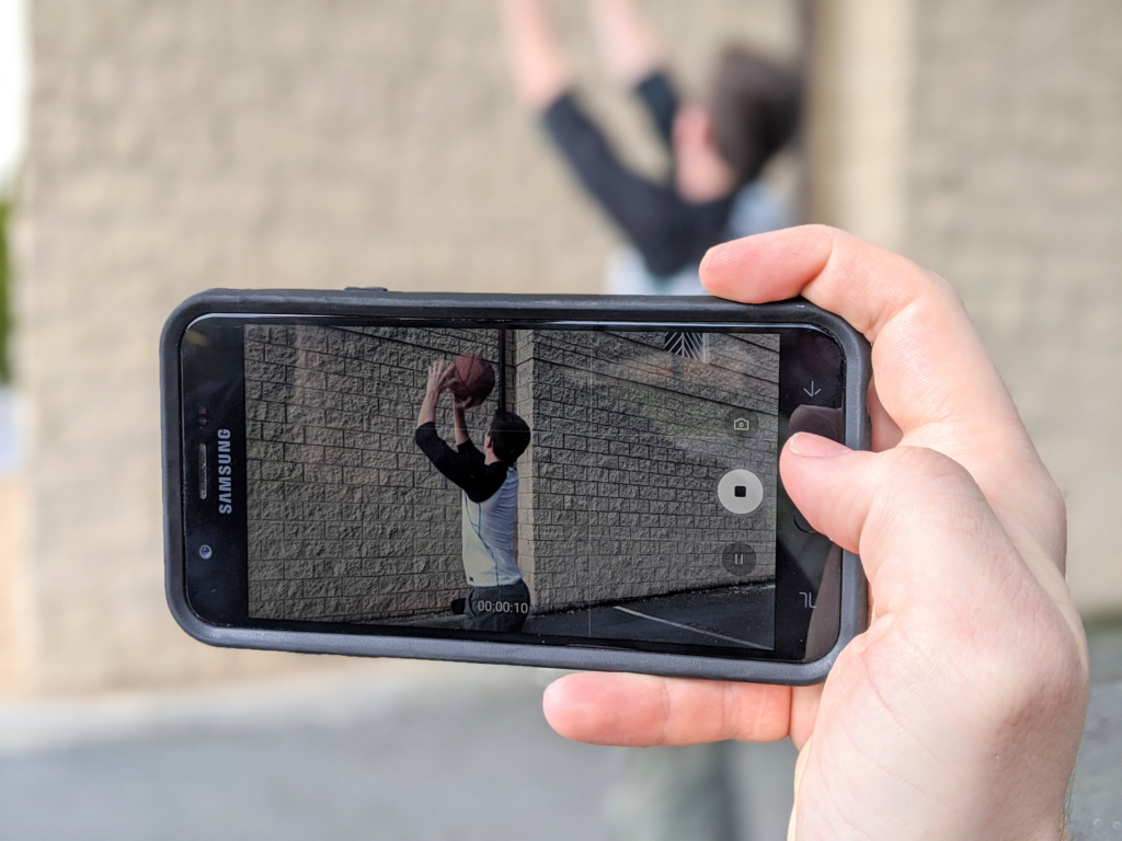 Holding a smartphone to capture a video