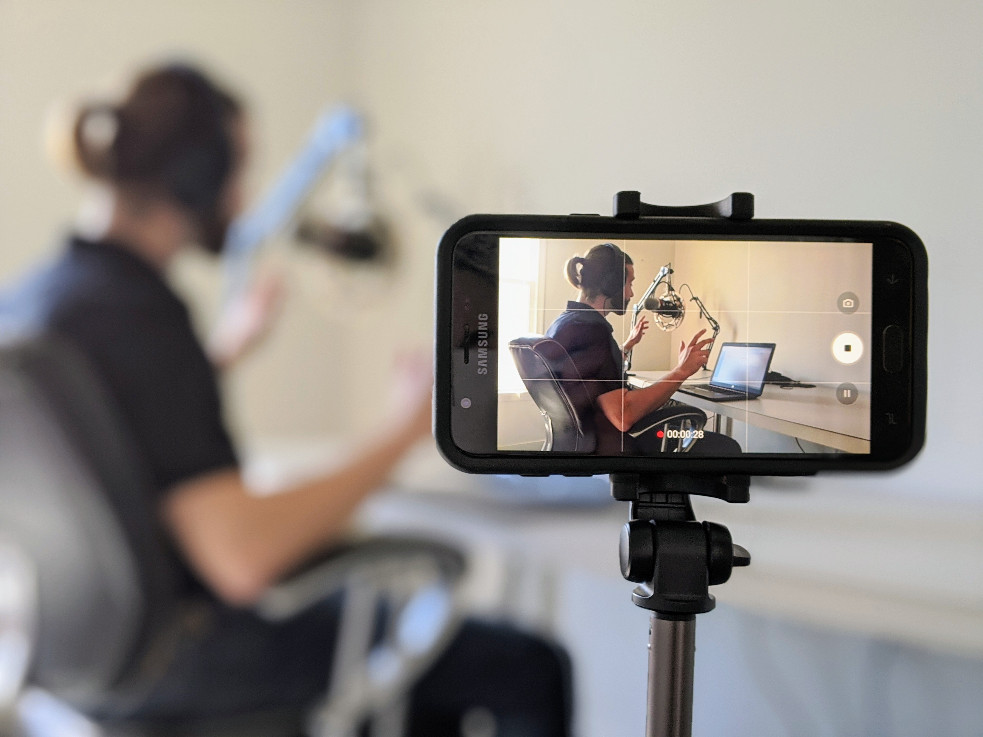 Filming a podcast recording with a smartphone on a tripod