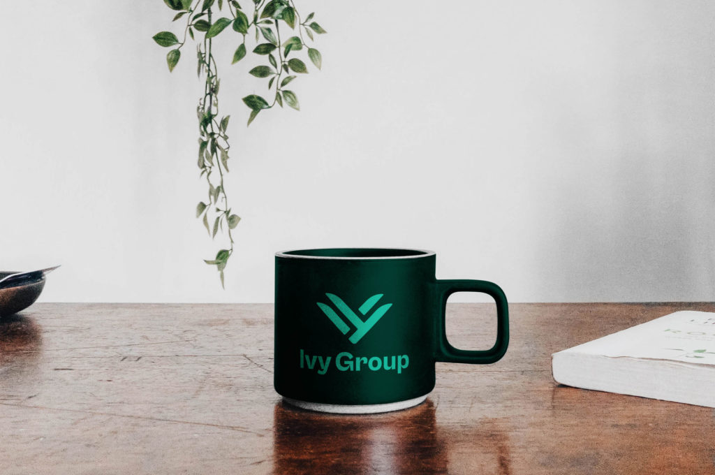 Ivy Group branded SWAG, mug on work table