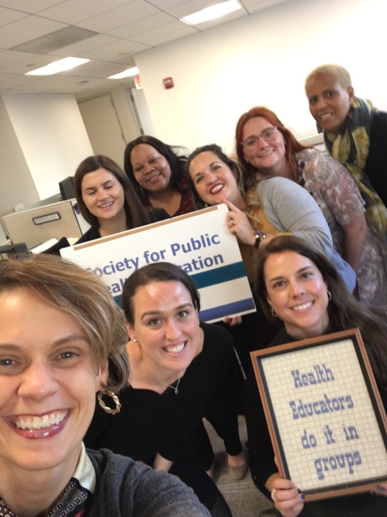 An Ivy Groupie posing with the SOPHE team in their office